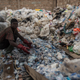 A worker in Accra sorts plastic for recycling.